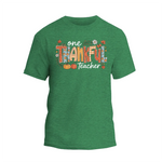 A green t-shirt with a colorful graphic design that says "One Thankful Teacher" in a stylized font.