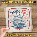 a person holding up a piece of paper with a ship on it