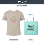 Beige t-shirt with red smiley face design and teal tote bag with 'Travel is my therapy' text. DTF Transfers By Size