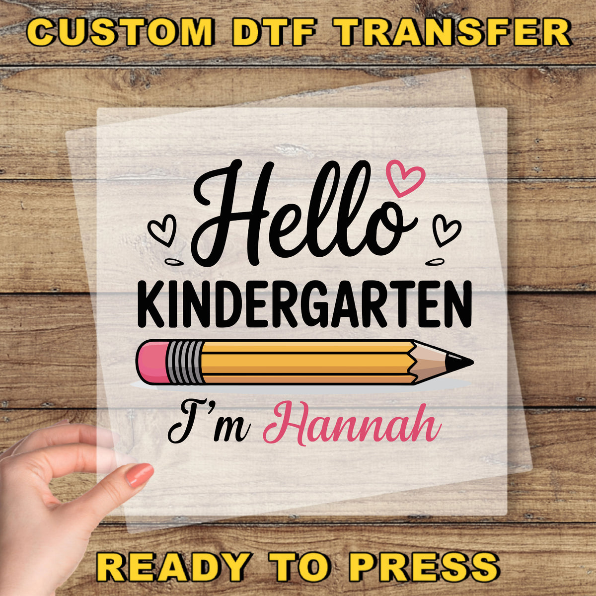 A hand holding a piece of paper with a hand-drawn pencil and the text "Hello Kindergarten I'm Hannah" printed on it.