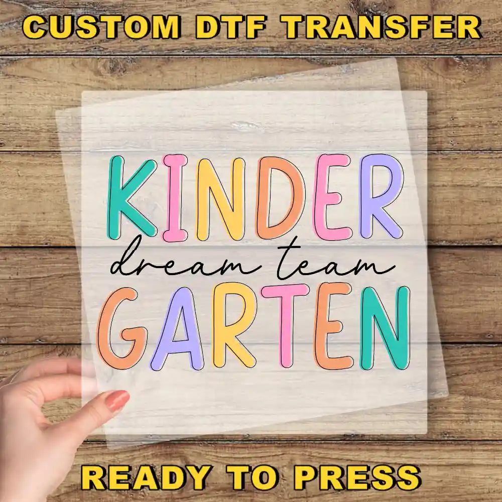 a hand holding a piece of paper with the words kinder dream team garter