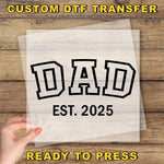 a person holding a piece of paper with the words dad on it