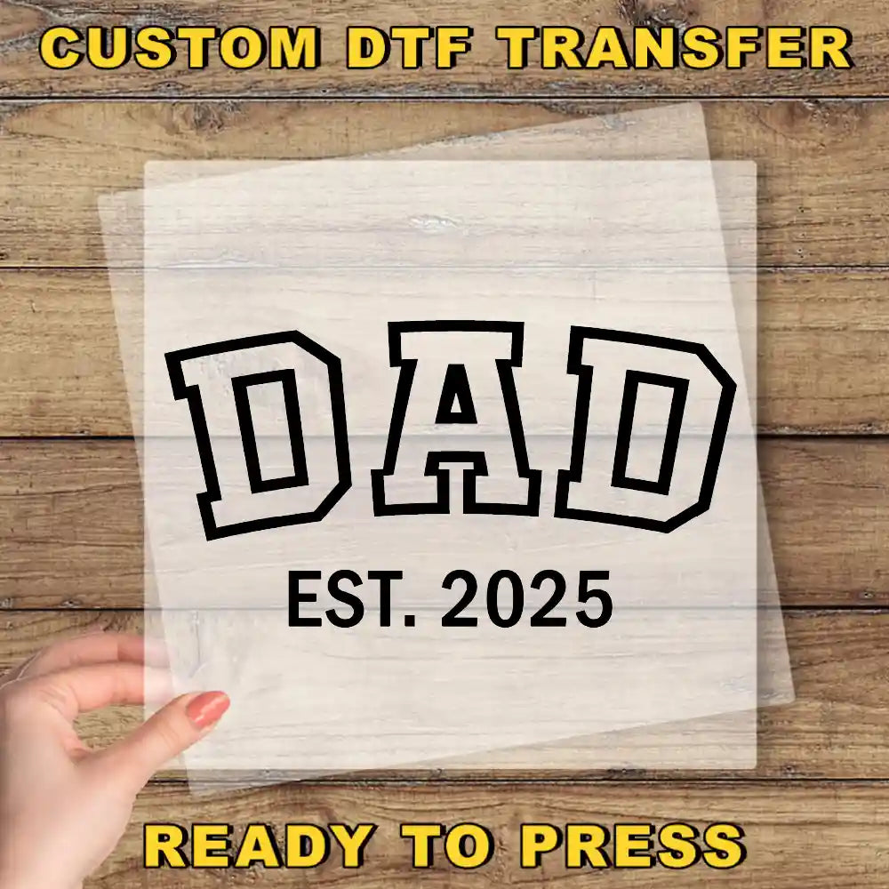 a person holding a piece of paper with the words dad on it