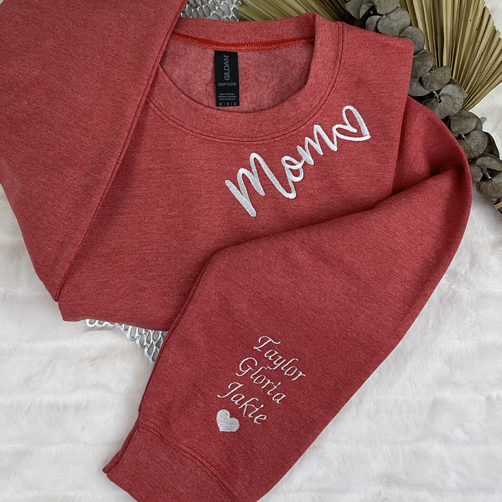 a couple of red shirts sitting on top of a bed