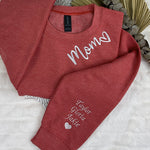 a couple of red shirts sitting on top of a bed