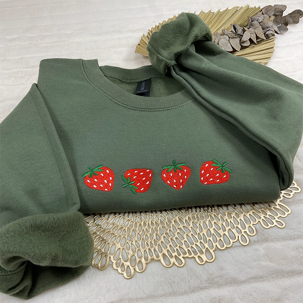 a green sweatshirt with strawberries on it