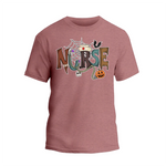 A pink t-shirt with the word "NURSE" written in a creative and colorful design, featuring various Halloween-themed elements such as a spider web, bats, a jack-o-lantern, and a nurse's cap.