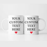 two white coffee mugs with red hearts on them