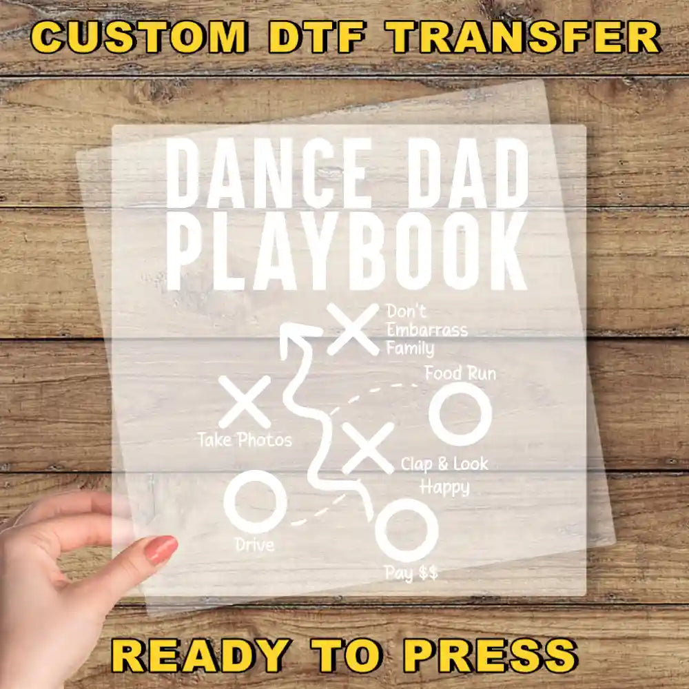 a person holding a piece of paper with the words dance dad playbook on it