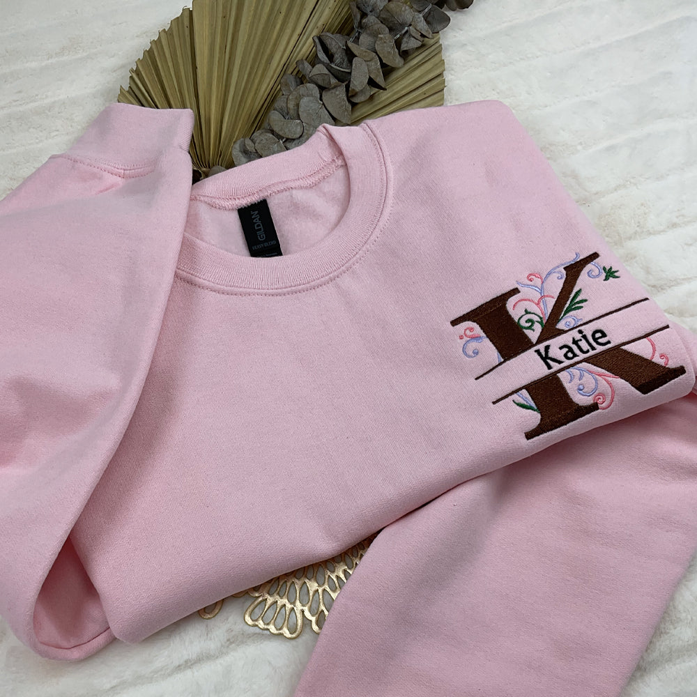 a pink sweatshirt with a tree on it