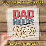 a person holding a piece of paper with the words dad needs beer
