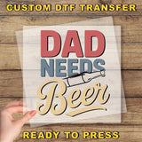 a person holding a piece of paper with the words dad needs beer