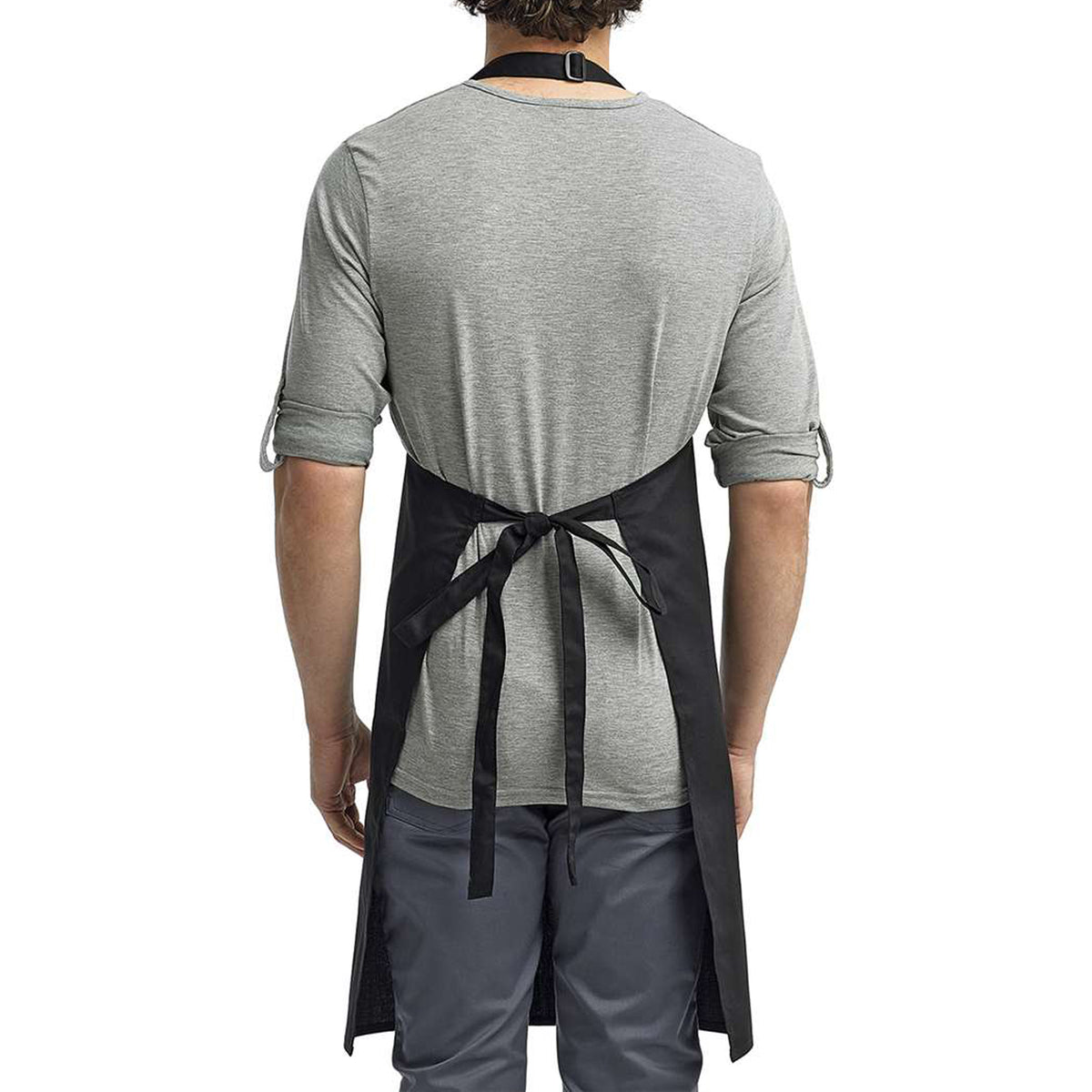 a man wearing a black apron and grey shirt