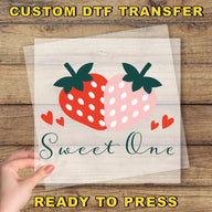 a hand holding a piece of paper with a strawberry on it