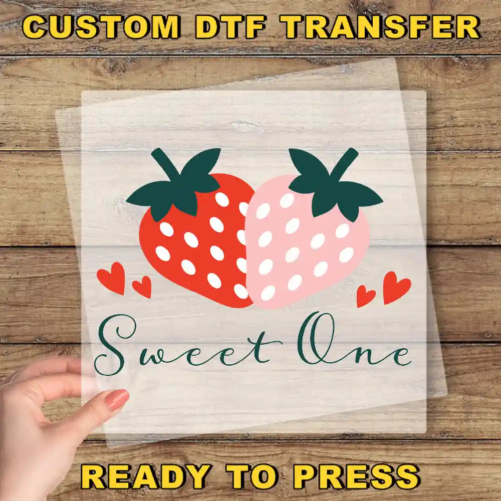 a hand holding a piece of paper with a strawberry on it