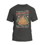 A gray t-shirt with a graphic design depicting a gingerbread house and the text "Baking Co. Gingerbread Bakes Daily Bake Fresh Daily Cookies Cakes - Plus Hot Chocolate".