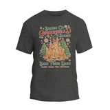 A gray t-shirt with a graphic design depicting a gingerbread house and the text "Baking Co. Gingerbread Bakes Daily Bake Fresh Daily Cookies Cakes - Plus Hot Chocolate".