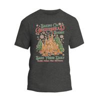 A gray t-shirt with a graphic design depicting a gingerbread house and the text "Baking Co. Gingerbread Bakes Daily Bake Fresh Daily Cookies Cakes - Plus Hot Chocolate".