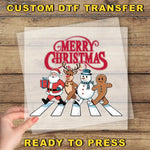 a hand holding a piece of paper with a christmas scene on it