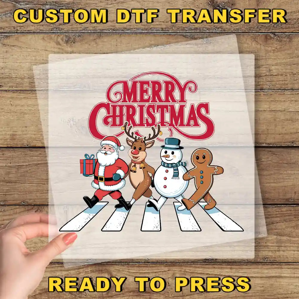 a hand holding a piece of paper with a christmas scene on it