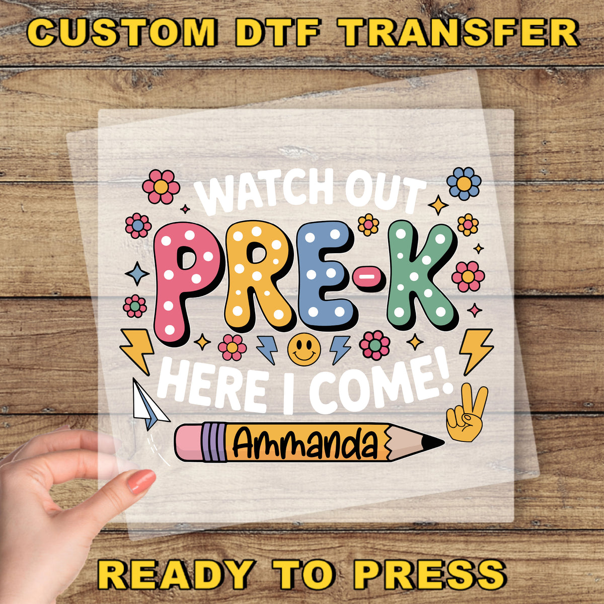 The image is a hand holding a piece of paper with a colorful and playful design featuring the text "Watch out PRE-K here I come!" and various decorative elements such as flowers, lightning bolts, and a pencil.