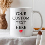 a white coffee mug with a red heart on it