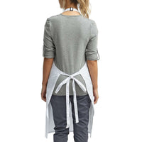 a woman wearing a grey top with a white tie around the waist