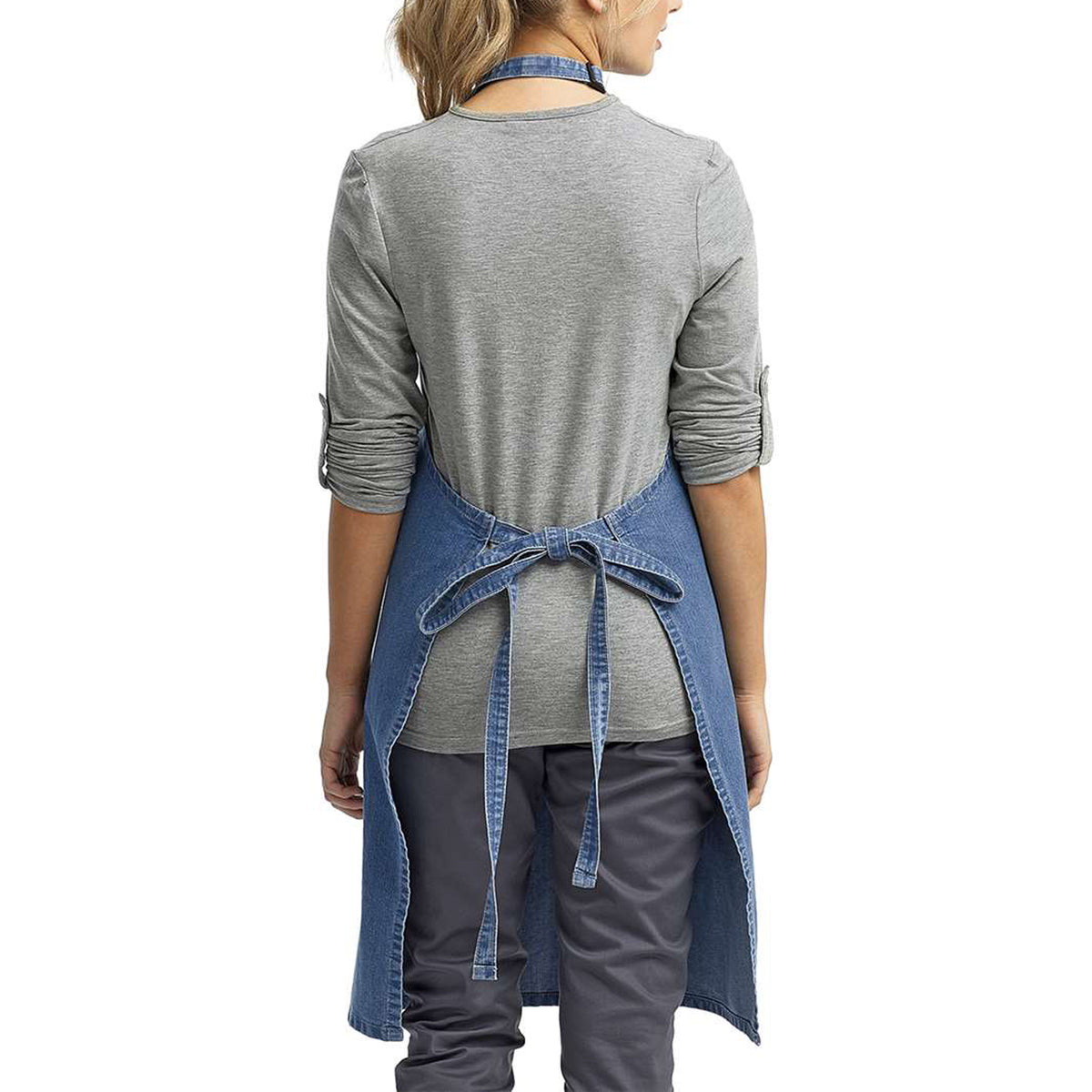 a woman wearing a denim apron and grey shirt