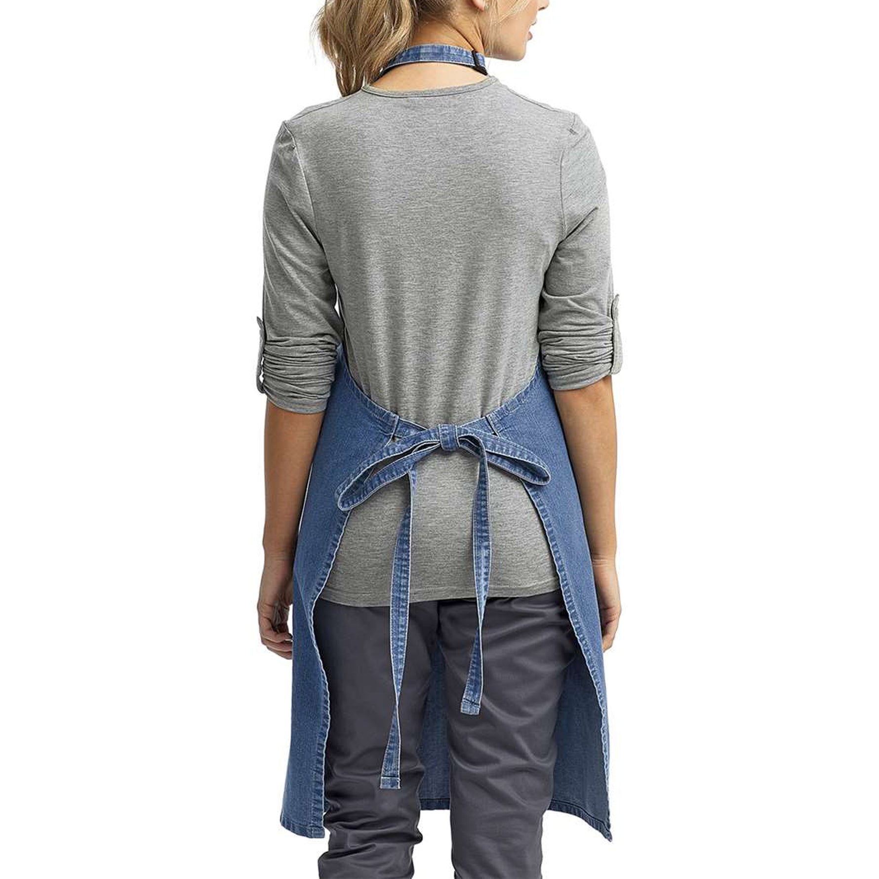 a woman wearing a denim apron and grey shirt