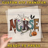 The image is a hand holding a piece of paper with the word "NURSE" written on it, along with various Halloween-themed elements such as a spider web, a bat, a pumpkin, and a skeleton.