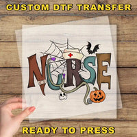The image is a hand holding a piece of paper with the word "NURSE" written on it, along with various Halloween-themed elements such as a spider web, a bat, a pumpkin, and a skeleton.