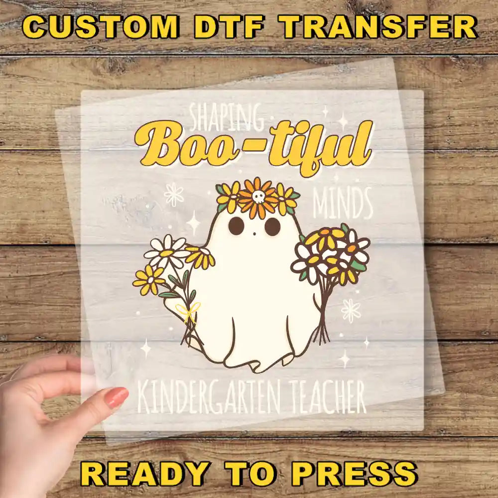 a hand holding a paper with a picture of a ghost on it