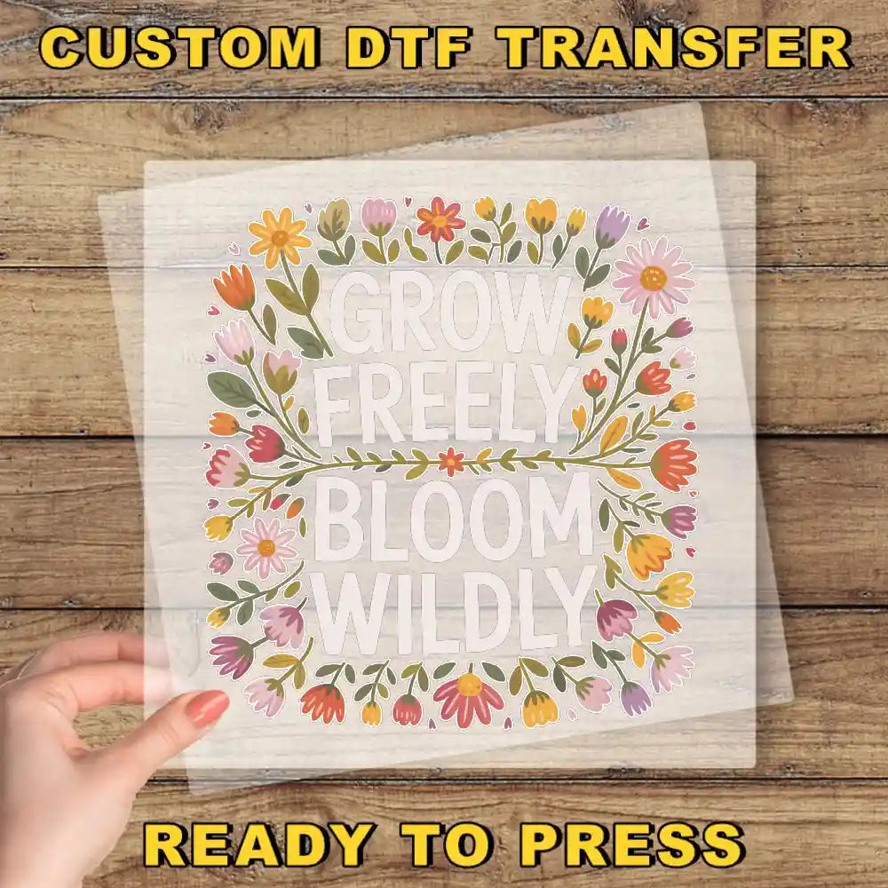 a hand holding a piece of paper with the words grow freely bloom wildly on it