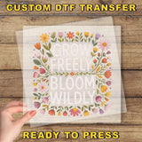 a hand holding a piece of paper with the words grow freely bloom wildly on it