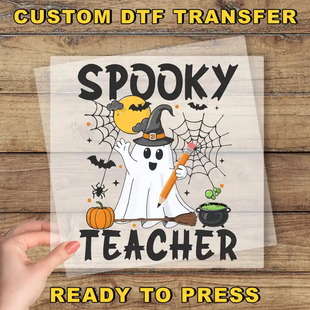 a hand holding a paper with a picture of a spooky teacher on it