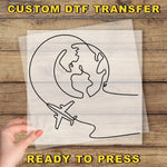 a hand holding a piece of paper with a drawing of a plane flying around the