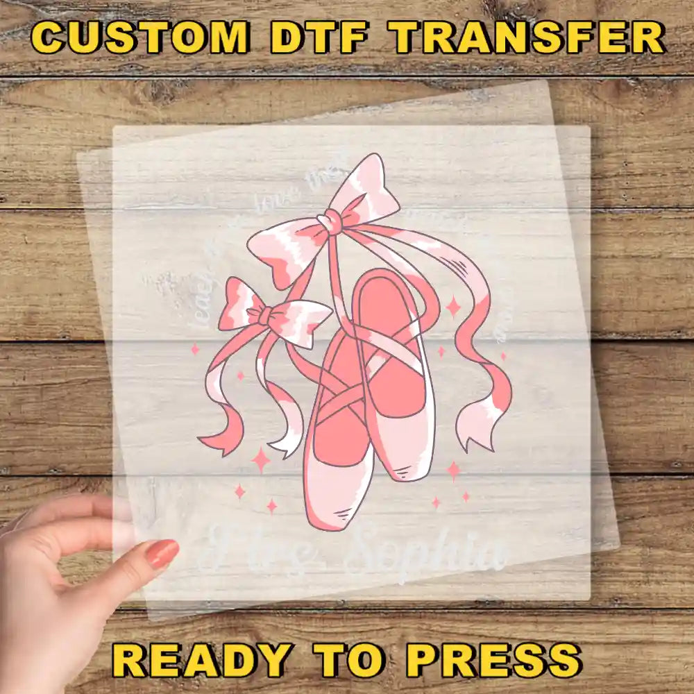 A hand is holding a clear sheet with a pink ballet shoe illustration on it, along with the text "I love Sophia" written below the illustration.