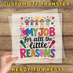 The image is a hand holding a sheet of paper with a colorful and artistic design featuring a message about loving one's job for all the little reasons.