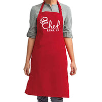 a woman wearing an apron with a chef's name on it
