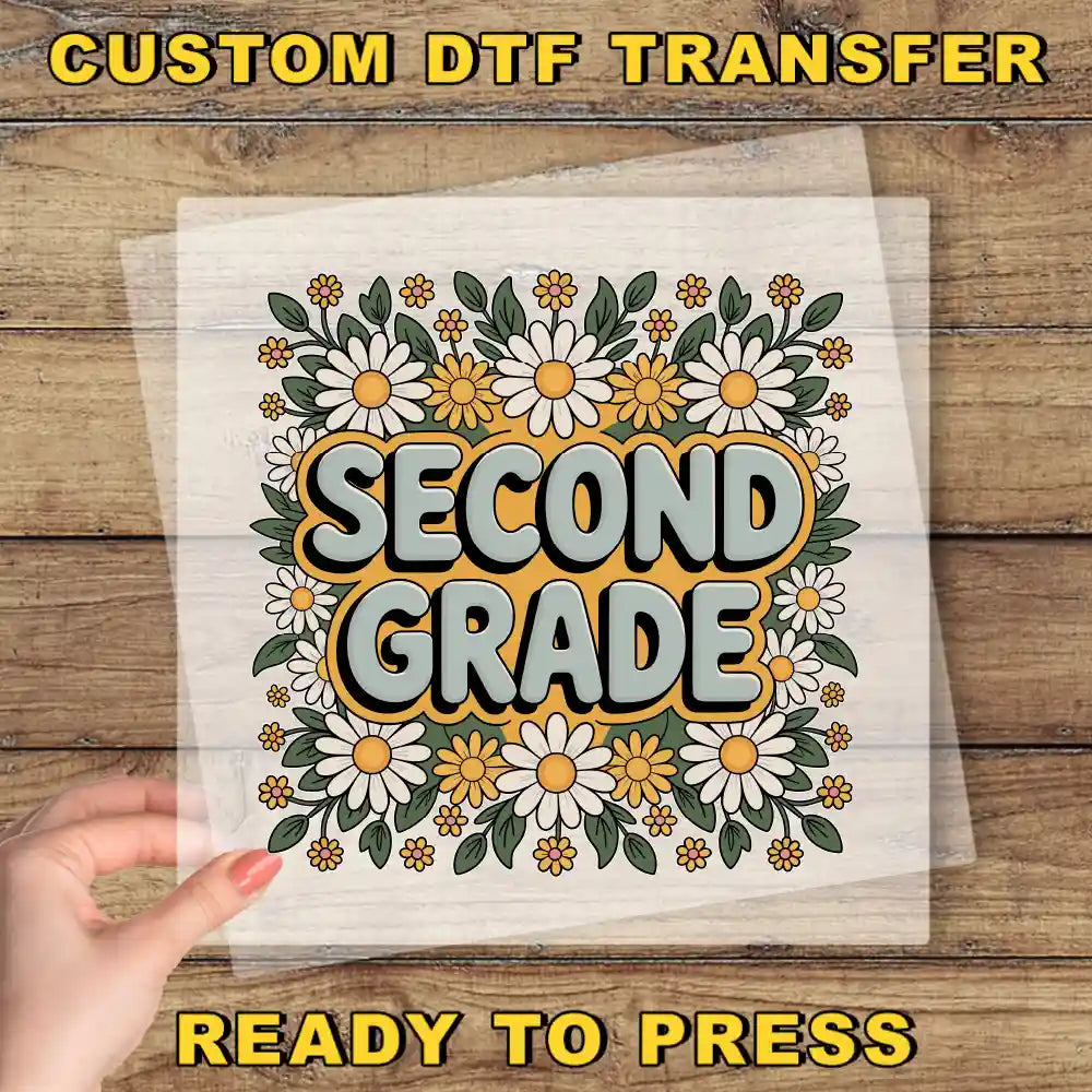 a hand holding a clear sheet with a colorful floral design and the text "Second Grade" printed on it.