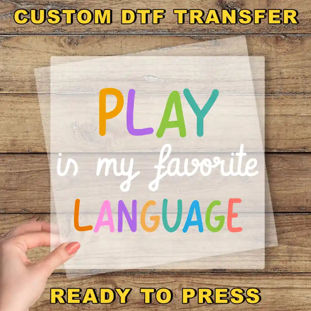 a hand holding a piece of paper that says play in my favorite language