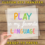a hand holding a piece of paper that says play in my favorite language