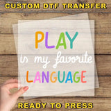 a hand holding a piece of paper that says play in my favorite language