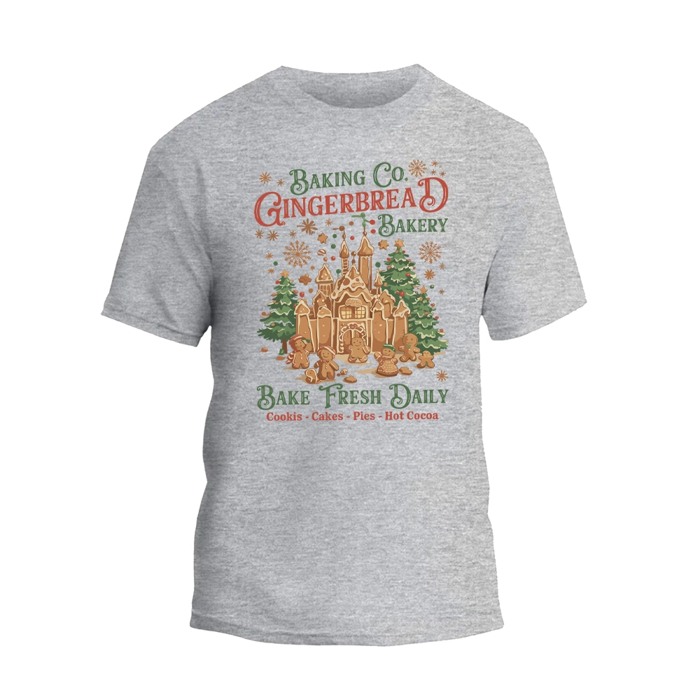 A gray t-shirt with a graphic design featuring a gingerbread house and the text "Baking Co. Gingerbread Bakery Bake Fresh Daily Cookies Cakes Pies Hot Cocoa".