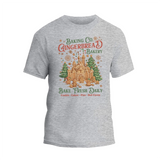 A gray t-shirt with a graphic design featuring a gingerbread house and the text "Baking Co. Gingerbread Bakery Bake Fresh Daily Cookies Cakes Pies Hot Cocoa".