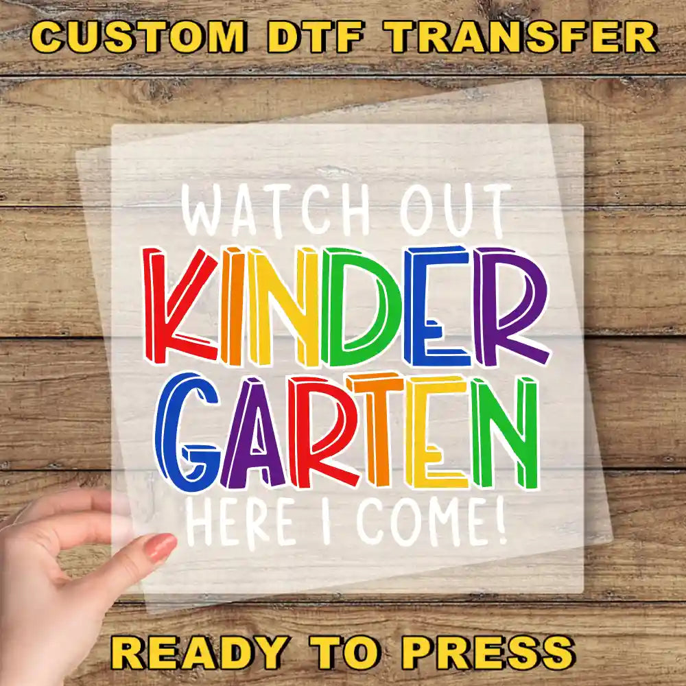 a hand holding a piece of paper that says, watch out kinder garden here
