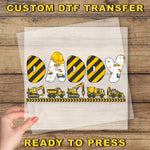 a person holding a piece of paper with construction vehicles on it