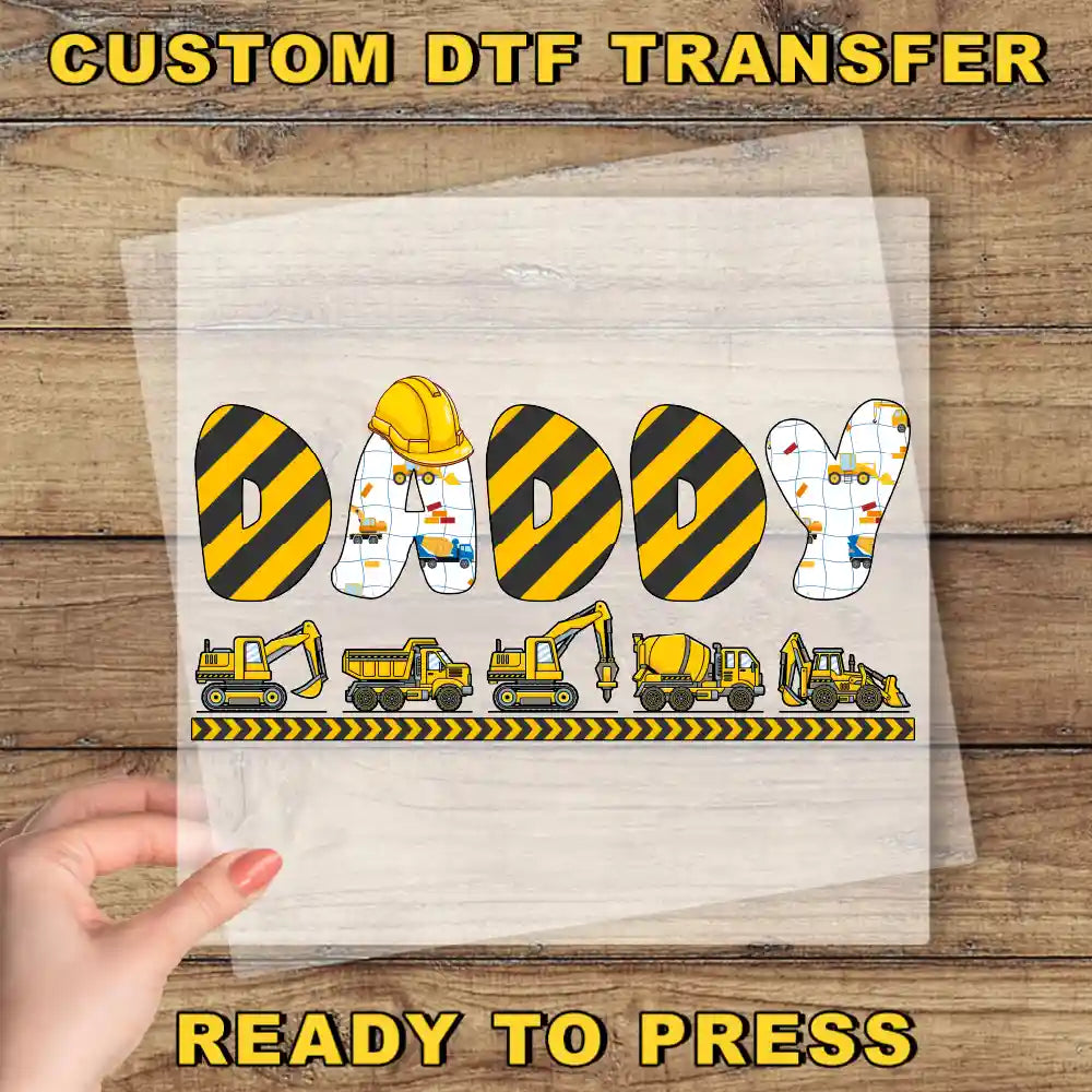 a person holding a piece of paper with construction vehicles on it