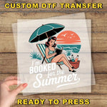 A hand holding a transparent sheet with a vintage-style illustration of a woman reading a book under an umbrella on a beach.