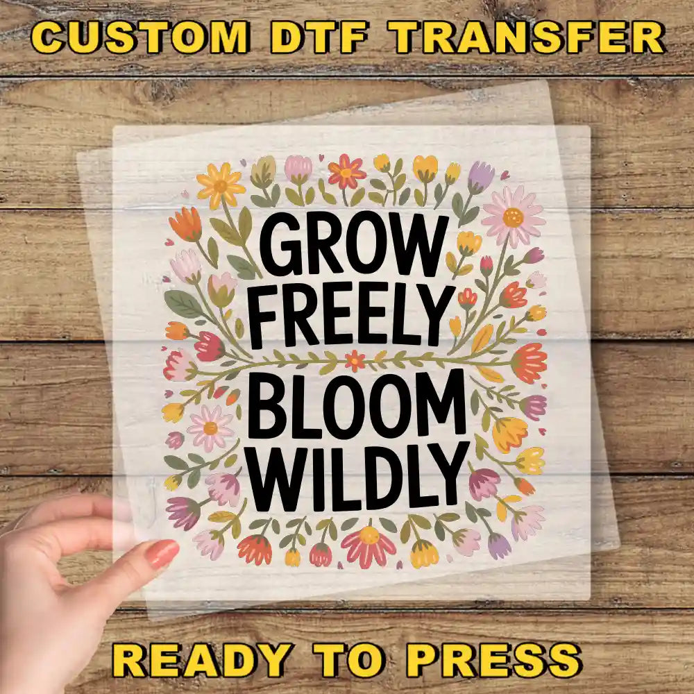 a hand holding a piece of paper that says grow freely, bloom wildly